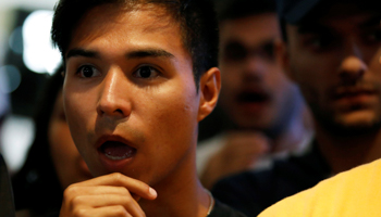 Opposition supporters listen to the election results (Reuters/Carlos Garcia Rawlins)