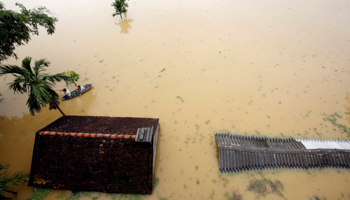 Farmers paddle in a boat at a flooded village after a tropical depression in Hanoi, Vietnam, October 13, 2017 (Reuters/Kham)