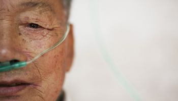 A patient breathes using a nasal cannula at a hospital in Zhejiang Province (Reuters/Damir Sagolj)