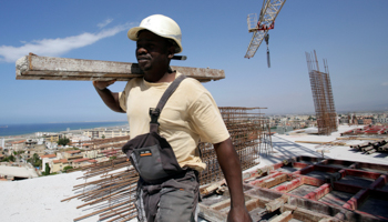 A migrant from Guinea works at the construction site of a building in Algiers, Algeria (Reuters/Ramzi Boudina)