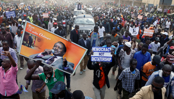 Supporters of Kenyan opposition leader Raila Odinga of the National Super Alliance, NASA, coalition carry banners as they welcome Odinga's return to Nairobi, Kenya (Reuters/Baz Ratner)