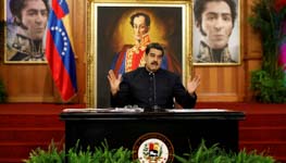 President Nicolas Maduro at a press conference, backed by images of Liberator Simon Bolivar (Reuters/Carlos Garcia Rawlins)
