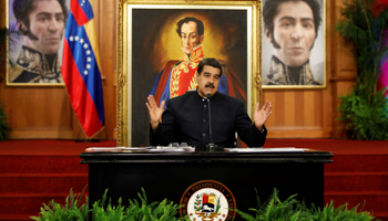 President Nicolas Maduro at a press conference, backed by images of Liberator Simon Bolivar (Reuters/Carlos Garcia Rawlins)