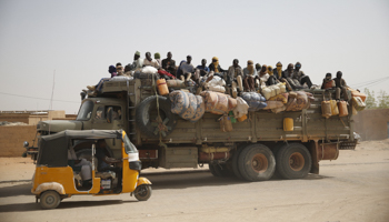 Migrants sit in the back of a truck in the desert town of Agadez, Niger (Reuters/Akintunde Akinleye)