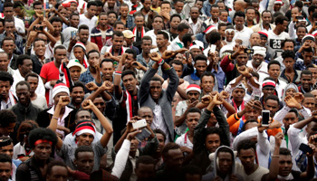 Demonstrators flashing the Oromo protest gesture in Bishoftu town, Ethiopia (Reuters/Tiksa Negeri)