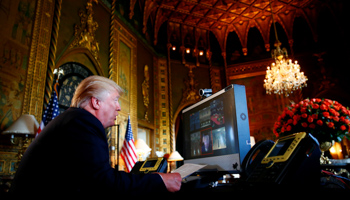 President Donald Trump speaks with US troops via video teleconference from Florida (Reuters/Eric Thayer)