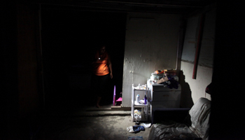 A woman using a flashlight in her home, two months after Hurricane Maria hit Puerto Rico (Reuters/Alvin Baez)