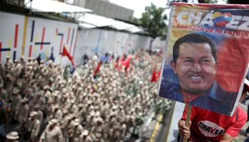 Venezuelan government supporters carry a poster of late President Hugo Chavez (Reuters/Ueslei Marcelino)