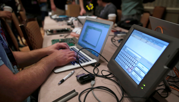A computer hacker tries to access information in a Voting Machine Hacking Village during the Def Con hacker convention in Nevada, US, July 2017 (Reuters/Steve Marcus)