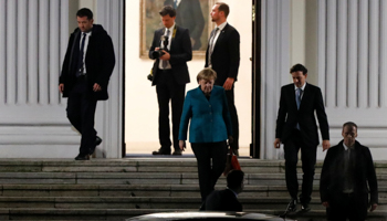 Chancellor Angela Merkel leaves after a joint meeting with Horst Seehofer and Martin Schulz, hosted by the German President Frank-Walter Steinmeier (Reuters/Axel Schmidt)