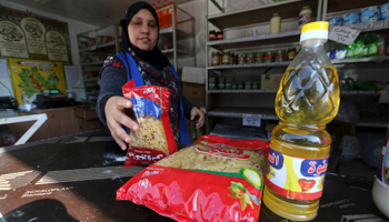 A worker sells subsidized food commodities at a government-run supermarket in Cairo, Egypt (Reuters/Mohamed Abd El Ghany)