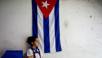 A girl waits for voters at a polling station in Havana, Cuba, November 26, 2017 (Reuters/Alexandre Meneghini)