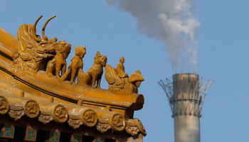 Smog rises from a chimney next to a traditional gate in Beijing (Reuters/Kim Kyung-Hoon)