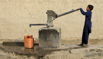 A boy drawing drinking water from a well in Peshawar (Reuters/Fayaz Aziz)