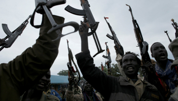 Fighters brandish their weapons in Kaya, South Sudan (Reuters/Goran Tomasevic)