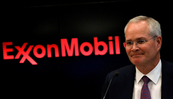 ExxonMobil CEO and the company logo (Reuters/Brendan McDermid)