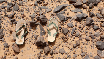 A pair of flip flops in the desert near the border between Algeria and Libya, 2014 (Reuters/Ahmed Jadallah)