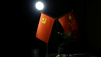 Chinese Communist Party flag next to a battery lamp (Reuters/Jason Lee)