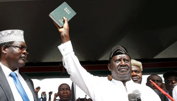Kenyan opposition leader Raila Odinga of the National Super Alliance holds a bible as he takes a symbolic presidential oath of office in Nairobi, Kenya, January 30, 2018 (Reuters/Baz Ratner)