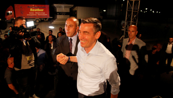 Ramush Haradinaj, left, arrives with Democratic Party, PDK, chief Kadri Veseli, as supporters of the coalition of former Kosovo Liberation Army commanders celebrate the first results of elections in Pristina, June 12, 2017 (Reuters/Agron Beqiri)