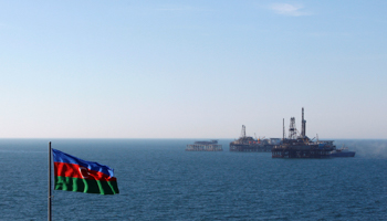 Caption - Azerbaijani oil rigs in the Caspian Sea (Reuters/David Mdzinarishvili)