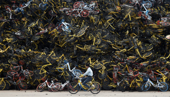 Piled-up shared bikes at a vacant lot in Xiamen, China (Reuters/Stringer)