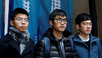 Activists Joshua Wong, Alex Chow and Nathan Law pose outside the Court of Final Appeal in Hong Kong (Reuters/Bobby Yip)