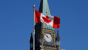 A Canadian flag flies in front of the Peace Tower on Parliament Hill in Ottawa, Ontario (Reuters/Chris Wattie)