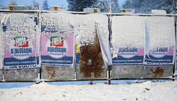 Electoral posters are seen during a heavy snowfall in Rome (Reuters/Max Rossi)