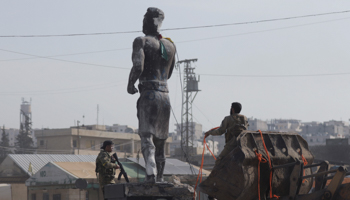 Turkish-backed Free Syrian Army members pull down a Kurdish statue in Afrin, Syria, March 18 (Reuters/Khalil Ashawi)