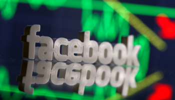 A 3D-printed Facebook logo in front of displayed stock graph (Reuters/Dado Ruvic)