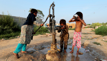 Children drinking water from a hand pump in Islamabad (Reuters/Caren Firouz)