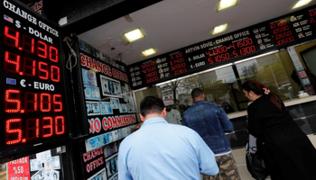 People change money at a currency exchange office in Istanbul (Reuters/Murad Sezer)