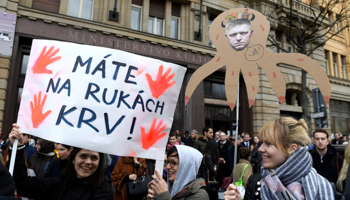 Banner “You have blood on your hands” and caricature of former Prime Minister Robert Fico at rally in Bratislava on April 5 demanding action after murder of investigative reporter Jan Kuciak (Reuters/Radovan Stoklasa)