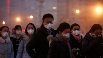 People wearing face masks on a polluted day in Beijing, China (Reuters/Thomas Peter)