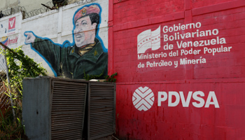 A mural featuring late President Hugo Chavez and the PDVSA logo (Reuters/Carlos Garcia Rawlins)