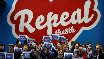 Protestors under a Pro-Choice 'Repeal the 8th Amendment' mural outside the Project Arts centre before the murals removal in Dublin, Ireland (Reuters/Clodagh Kilcoyne)