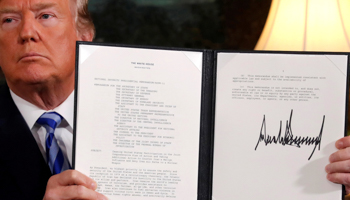 US President Donald Trump holds up a proclamation declaring his intention to withdraw from the Iran nuclear deal, May 8, 2018 (Reuters/Jonathan Ernst)