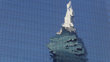 A building is reflected on office windows in the banking area of Panama City, Panama (Reuters/Carlos Jasso)