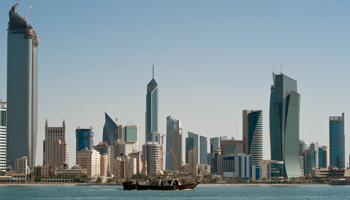 A fishing boat passes in front of the Kuwait City skyline (Reuters/Stephanie McGehee)