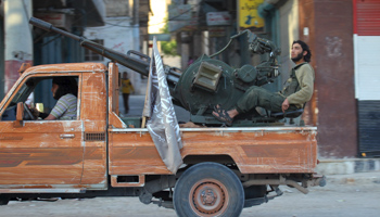 Members of al-Qaida's Jabhat al-Nusra ride on a pick-up truck mounted with an anti-aircraft weapon in Idlib, May 2015 (Reuters/Ammar Abdullah)