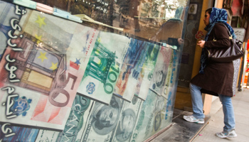 A woman enters a currency exchange shop in Tehran's business district (Reuters/Raheb Homavandi)