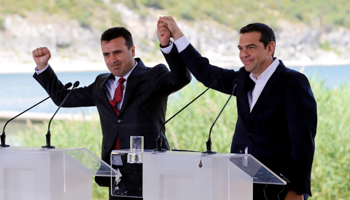 Greek and Macedonian premiers Alexis Tsipras (right) and Zoran Zaev (left) hail ‘Northern Macedonia’ accord in Prespes, June 17 (Reuters/Alkis Konstantinidis)