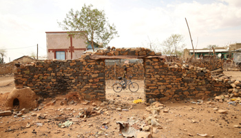 A boy rides past houses in Badme damaged during the Ethiopia-Eritrea war, June 8, 2018 (Reuters/Tiksa Negeri)