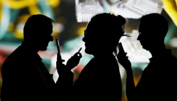 People looking at their smartphones (Reuters/Kacper Pempel)