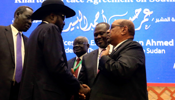 President Salva Kiir, opposition leader Riek Machar and Sudan's President Omar al-Bashir talk after signing a peace agreement, Khartoum, June 27 (Reuters/Mohamed Nureldin Abdallah)