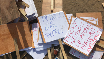 Signs from an opposition rally protesting oil contracts with international firms in Dakar, 2016 (Reuters/Edward McAllister)