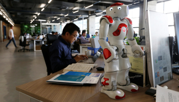 Staff work behind a robot at start up company iCarbonX in China (Reuters/Bobby Yip)