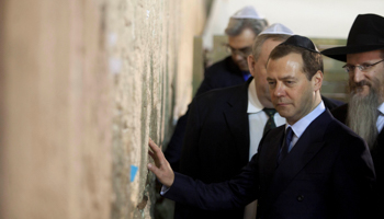Russia's Prime Minister Dmitry Medvedev touches the stones during a visit to the Western Wall in Jerusalem (Reuters/Dan Balilty)