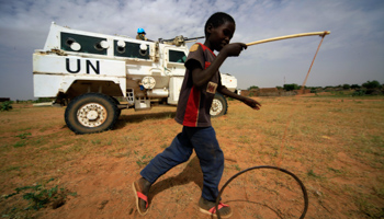 A boy plays in front of UNAMID peacekeepers in North Darfur, Sudan (Reuters/Mohamed Nureldin Abdallah)